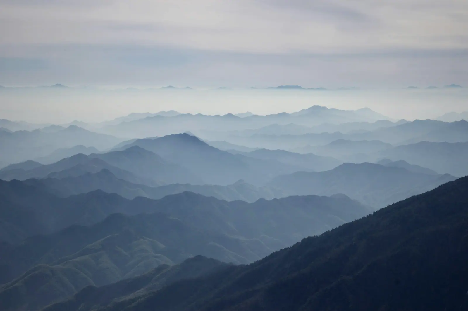 Ridge after ridge fading away, blue-grey mist lying in the valley