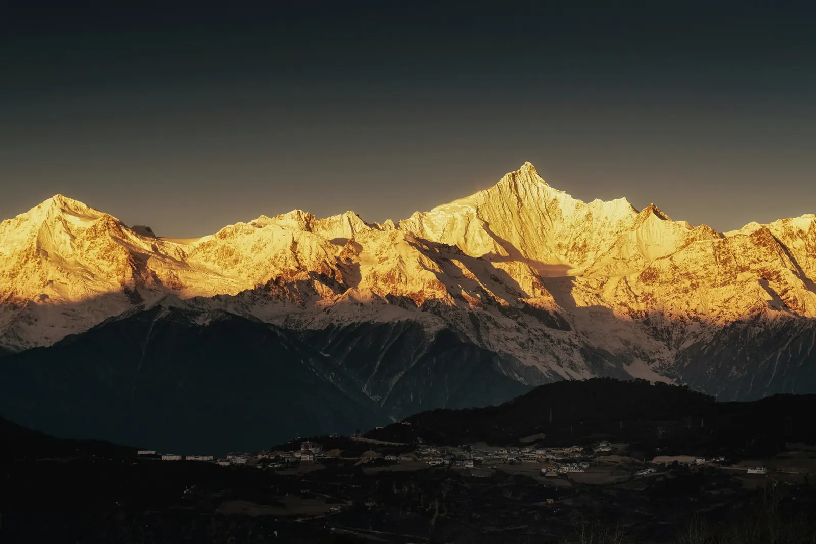 Snow mountains turned gold at sunset