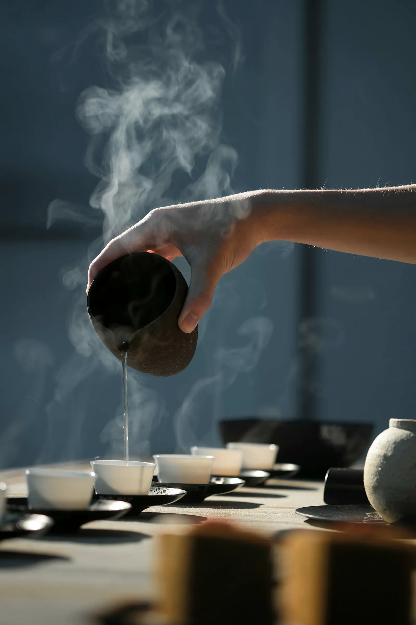 Hot water streaming from a spout, steam rising